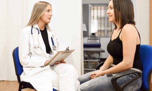 Female doctor explaining diagnosis to her young woman patient.